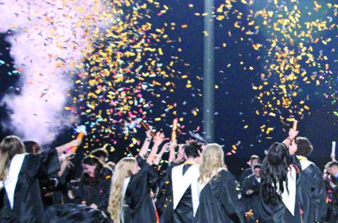 Sentinel Photo/Jessica Shepard Van Vleck High School's Class of 2023 added confetti and colored powder cannons to their traditional cap-throwing finale for the graduation ceremony. 