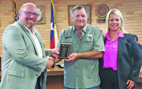 Sentinel Photo/Jessica Shepard Van Vleck ISD school board President Tony Kucera, center, was recognized for his 15 years of service to the district Monday night. The award was presented on behalf of the Region 3 Education Service Center with R3 ESC Execurive Director Morris Lyon and VVISD Superintendent Christie Dement thanking Kucera as well.