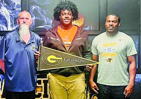 Courtesy photo Blackcat senior Zomaryon Bryan received a scholarship to play football at Grambling State University. Bryan, center, is flanked by Offensive Line Coach Ron Arneson, left, and Head Football Coach Robert Jones. 