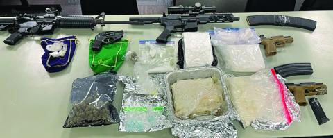 Police show guns and drugs taken after search warrant was served at 2900 block of Avenue I