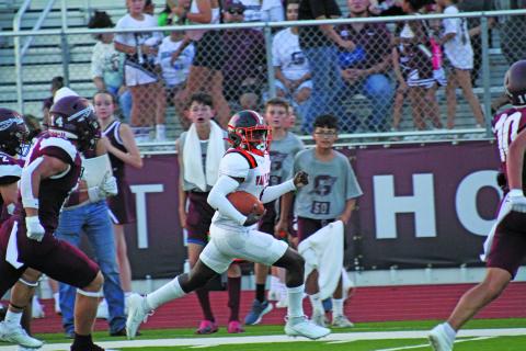 Anna Hernandez photo A Van Vleck runner stays ahead of Ganado defenders.