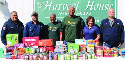 Sentinel Photo/Jessica Shepard As part of its "Global Care Day," several LyondellBasell employees brought a generous food and personal care item and monetary donation to Bay City's Harvest House food pantry, on Monday, Oct. 16. The company chose to focus its care efforts in conjunction with "World Food Day" to combat food insecurities in communities across the world. 