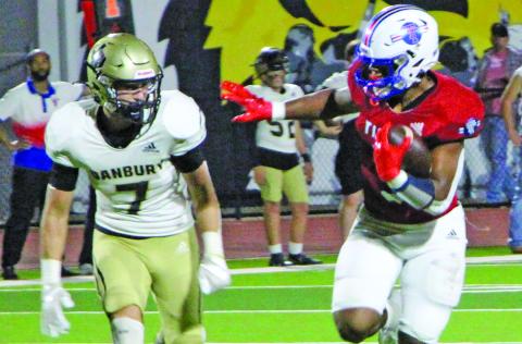 Sentinel Photo/Jessica Shepard Above, Tidehaven running back Joseph Dodds (5) prepares to stiff arm a Danbury defender.