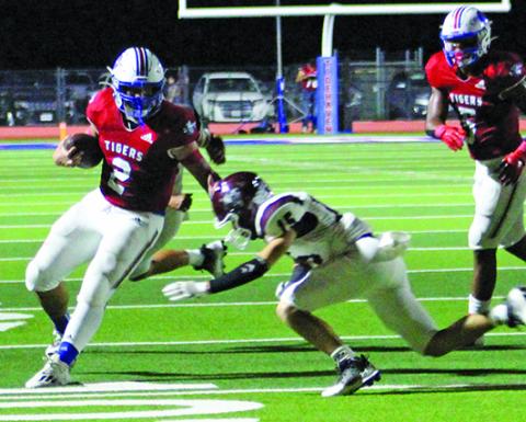 Sentinel Photo/Jessica Shepard Tidehaven running back Jachen Duran (2) stiff arms an East Bernard defender at last Friday contest at home.