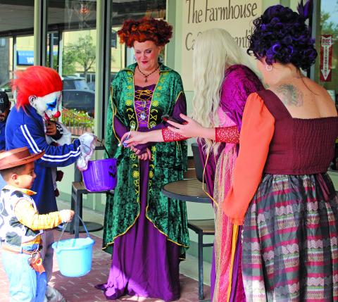 Sentinel Photo/Jessica Shepard Trick-or-treaters got to see the famous trio known as the Sanderson Sisters Witches up close at The Farmhouse Face & Merchantile during "Trick or Treat Around the Square" Oct. 31. Many downtown businesses featured costumed employees along with their free candy distribution efforts. 