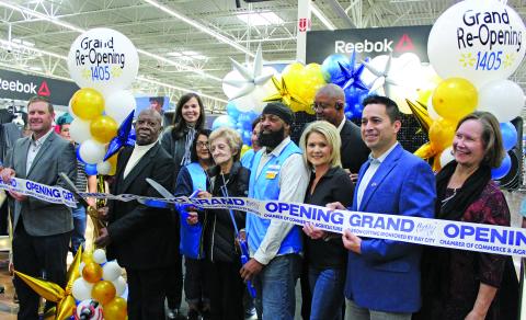 Sentinel Photo/Jessica Shepard Bay City Walmart partnered with the Bay City Chamber of commerce to celebrate its "Grand re-opening" with a ribbon-cutting ceremony on Friday, Nov. 3. Walmart employees with over 30 years in the company were on hand to help cut the ribbon align with store and city officials.