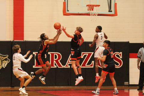 Photo by Anna Hernandez Leopard defense was in full effect against Brazos and both Van Vleck No. 11 Keemer Allums and No. 21 Micah Burks go up.t
