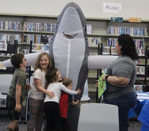 Sentinel Photo/Jessica Shepard Sharky made an appearance at Bay City Public Library’s “Take your Child tot he Library” event, Saturday, Feb. 3. Children and parents were treated to a shark storytime and craft.