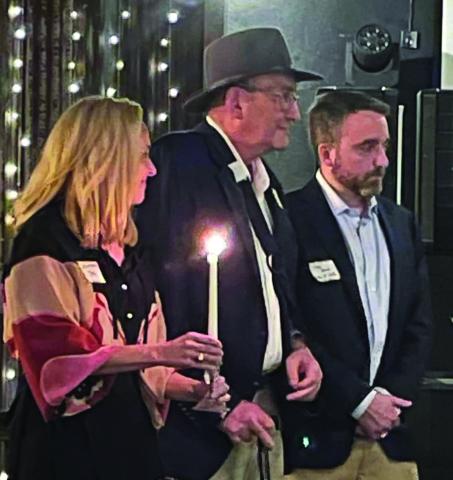 Contributed photo George Harrison, flanked by his two children, attended Aggie Muster Sunday, April 21, a solemn ceremony that remembers Aggies who have passed away. Among the names called of Aggies who have died, was Donna Harrison ‘75, George Harrison’s wife and the mother of his two children both of whom are former students of Texas A&M University.