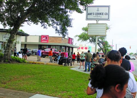 Sentinel Photo/Jessica Shepard The line for Amy's Cookie Co. and Bakery's grand opening stretched down the block on May 2. The bakery is located at 2808 7th St. in Bay City.