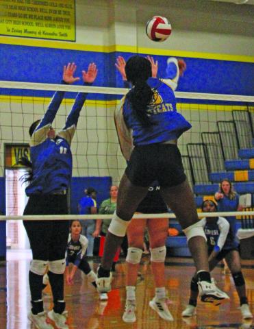 Anna Hernandez photo  Bay City’s Sasha Onweckekwa (8) strikes the ball past the Louise defenders at the net in a recent game.