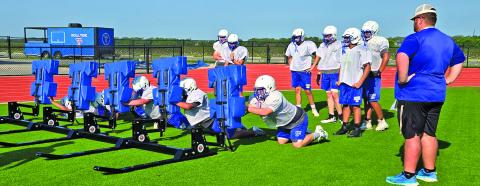 A Tidehaven coach watches players technique on the blocking sled. Sentinel photo/ MaLinda Reddell