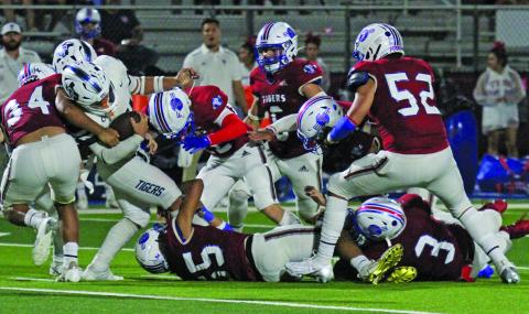 Photo by Anna Hernandez Tidehaven tacklers converge on a Goliad running back in the Tigers matchup against Goliad last week.