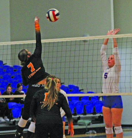 Photo by Anna Hernandez Above right, Van Vleck’s Lakyn Matchett (7) tips the ball over the net with Tidehaven’s  Raylea Kelley (5) defending during the game between the two Matagorda County teams Aug. 27. Tidehaven won 3-0.