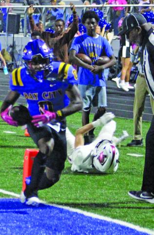 Sentinel Photo/Jessica Shepard Bay City’s Jada Andrews (0) sheds a Floresville tackler en route to the first of his three touchdowns on the night. 