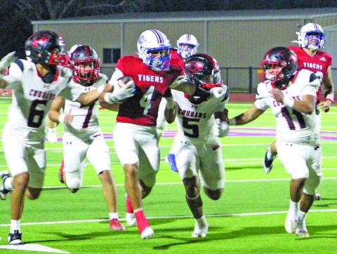 Sentinel Photo/Jessica Shepard Tiger running back Boogie Galvan (4) tries to shake several Brazos defenders.