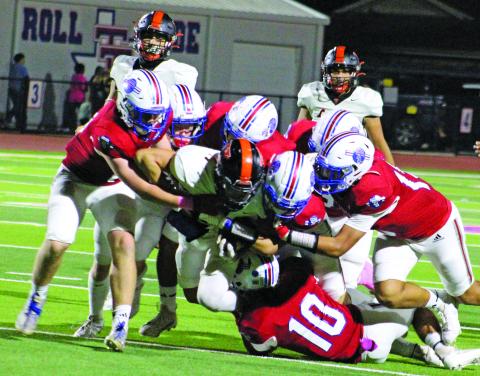 Sentinel Photo/Jessica Shepard Above left, Tidehaven defenders converge on Van Vleeck star running back Corey Austin.