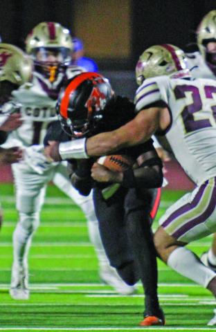 Photo by Anna Hernandez Leopard back Daniel Williams uses all his strength to move the ball down field while the Cotulla defense tries to bring him down. 