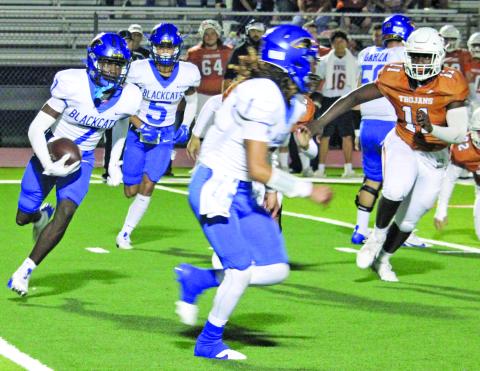 Sentinel Photo/Mike Reddell Blackcat senior wide receiver Xylan Williams (7) looks for blocking as senior quarterback Alex Estrada (1) leads the way against Beeville Friday night.