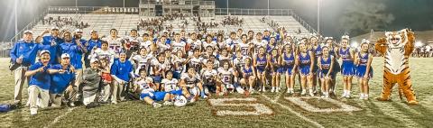 Photo/Lauren Russell Tidehaven players, cheerleaders, mascot and coaching staff celebrate the Tigers 3rd straight district championhip after defeating East Bernard Friday night.
