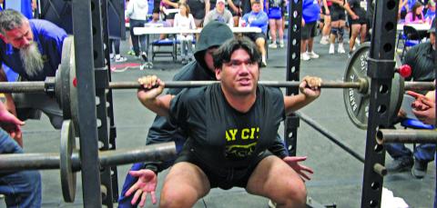 Sentinel Photo/Mike Reddell Blackcat powerlifter Jacob Perez strains in the squat under the watching eye of Coach Ron Arneso at the Tidehaven PL meet.