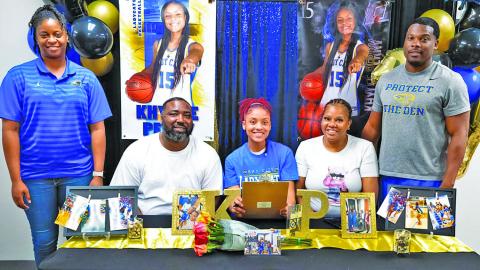 Courtesy photo Bay City Lady Cat guard Khylee Perry signed her letter of intent last week on National Signing Day. Perry will be playing for Hill College. 