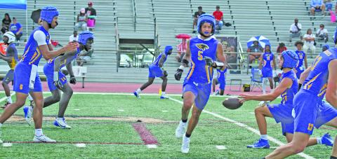 Photo by Anna Hernandez Bay City quarterback Jonus Edwards signals for the ball during the 7 on 7 game in West Columbia Saturday at their first 7 on 7 State Qualifying Tournament.