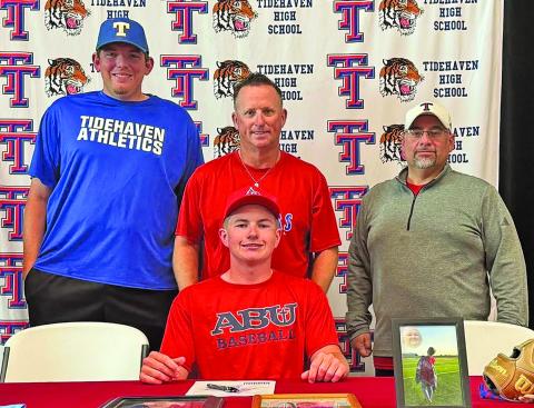 Tidehaven photo Tiger Camden Johnson was joined by Tidehaven coaches recently on his commitment to Arlington Baptist University (ABU) to play baseball.