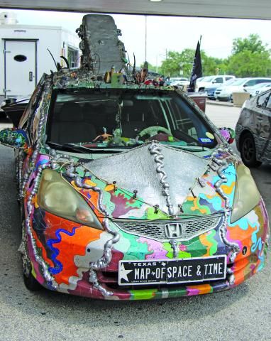 Sentinel Photo/Jessica Shepard One of the features at "Matagorda County ArtWalks: Summer Blues" event last Saturday. was three cars by Houston Art Car Klub. The one above has the unusual license plate of Map of Space & Time.