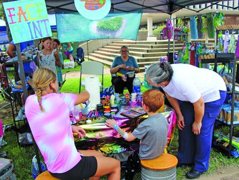 Sentinel Photo/Jessica Shepard A variety of vendor booths converged at Matagorda County Courthouse for the monthly return of "Downtown Bay City Market Days" Saturday, Aug. 23. Among the vendors was a face-painting station, above, that gave children and those young at heart the chance to have a custom work of art painted on their skin. 
