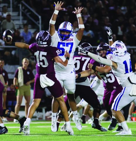 LeDarion Stone/Live in the Moment Photography Tidehaven defenders Jayden Torres (57) and Hayden McCarver make life uncomfortable for the Ganado quarterback.
