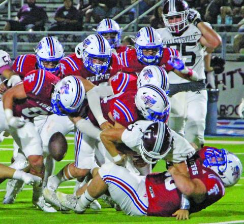 Sentinel Photo/Jessica Shepard A mountain of red Tidehaven jerseys covered this Hallettsville runnng back causing a loose ball.