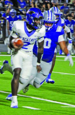 Sentinel Photo/Mike Reddell Blackcat junior quarterback Keimarion Williams (2) looks ahead for a gain with an Edna defender close behind.
