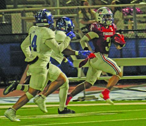 Anna Hernandez photo Tidehaven senior wide receiver TJ Galvan (3) locks in a big gain for the Tigers against Rice last Friday.