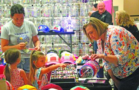 Sentinel Photo/Jessica Shepard Above, two young girls picked out their favorite headband designs at the Bay City Chamber of Commerce & Agriculture's annual "Market Day" event last Saturday. 