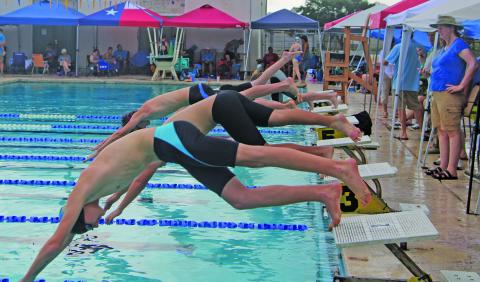 Sentinel Photo/Mike Reddell Bay City Aquacat divers present a lively look during competition at last Saturday’s Aquacat swim meet here. The threat of lightning forced the cancellation of the event. 