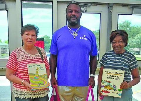 Contributed photo Matagorda County Retired Teachers Association's Barbara Evanicky, above left and Barbara Gordon, above right, delivered over 200 books to various places in Bay City and Van Vleck. Evanicky and Gordon are pictured with Cherry Elementary coach Terrance Flagg, center, while dropping off books at YMCA. Other locations include: Harvest House, Women’s Crisis Center, Vibrance Women’s and Children’s Health Center, Matagorda General Hospital’s Newborn Unit and Van Vleck Elementary.