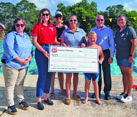 Phillips 66 photo Representatives from Phillips 66 and Bay City YMCA present $10,000 sponsorship check for the Phillips 66 Swim Safety Program.