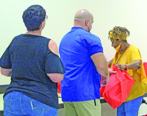 Sentinel Photo/Jessica Shepard Bay City Chamber of Commerce & Agriculture Education Committee volunteer and retired Bay City ISD staff member Donnye Stone, right, hands out goody bags to BCISD’s newest teachers at the annual “New Teacher Breakfast” on Aug. 6.