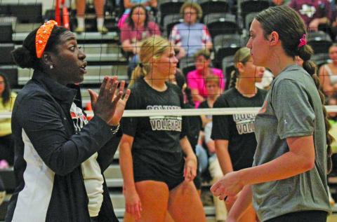 Photo by Anna Hernandez Van Vleck Volleyball Head Coach Evaree Rey talks to her player last week and explains what she should do next time in the game.