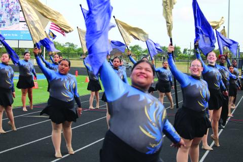 Members of the BCHS Color Guard rehearse their routines Friday evening, before the Bay City Blackcat - La Marque Cougar football game. Sentinel photo/ Mike Reddell 