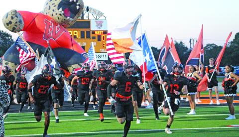 Sentinel Photo/Jessica Shepard The flag-bearing Van Vleck Leopards make their entrance to Burl McKinney Stadium last Friday for their game against Wharton. Van Vleck won 28-14. See Page 7 for more photos of the game.