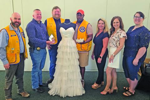 Sentinel Photo/Jessica Shepard Bay City Lions Club members pose with this year's Rice Festival Queen Pageant dress. From left are: Pageant Chairman Ryan Ricks, Festival Chairman Chris Hadash, Club President Chad Craft, and Cory McCray are joined by Green Bros. Jewelers representatives Erin Stone and Amanda Pitard with Pageant Director Rachel Ricks on Aug. 28. The dress and tiara are from El Campo's "New Beginnings Bridal & Prom" while Green Brothers provides the Queen's jewelry.