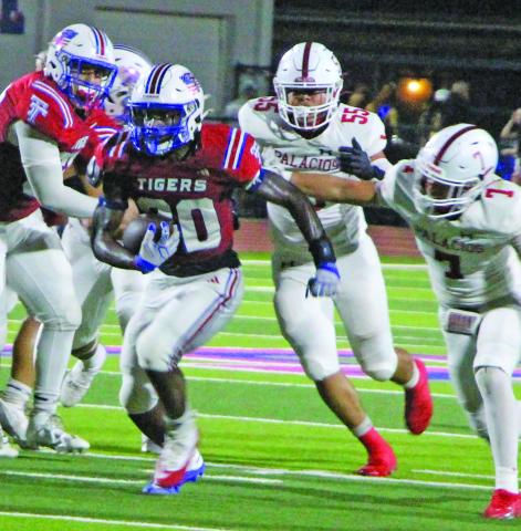 Sentinel Photo/Jessica Shepard Tiger running back Noah Riddick barrels through Palacios defenders. Riddick was Tidehaven’s leading rusher with 149 yards on 11 carries and two touchdowns.