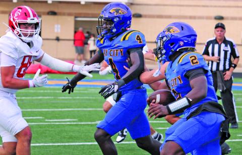 Sentinel Photo/Mike Reddell Blackcat running back Aiden Williams (4) leads the way for quarterback Keimarion Wiggins (2) to gain yardage agaist Columbus.