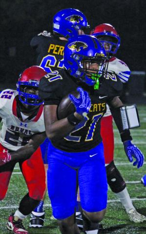 Bay City sophomore running back Davieon Agu (21) pulls away from Brookshire Royal defenders during last Friday’s Homecoming game. Sentinel Photo/ Mike Reddell