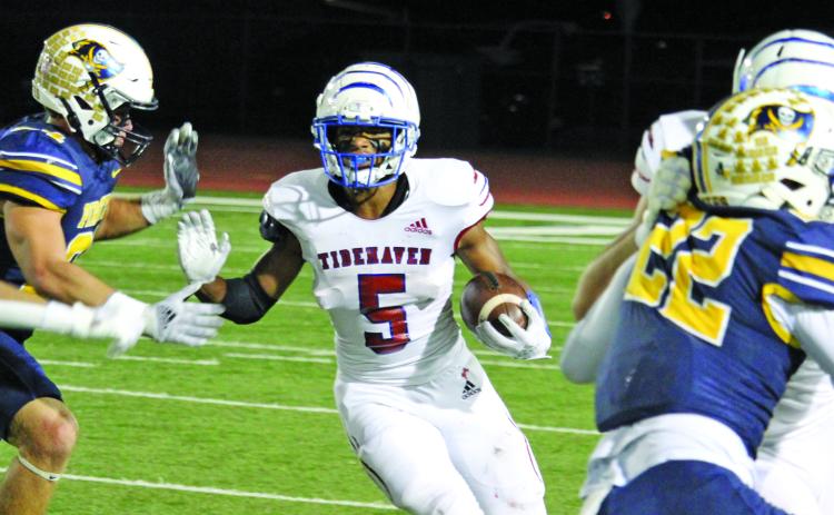 Sentinel photo/Mike Reddell Tidehaven sophomore running back Joseph Dodds (5), who had 141 all-purpose yards against Poth, looks for an opening created by his Tiger blockers.
