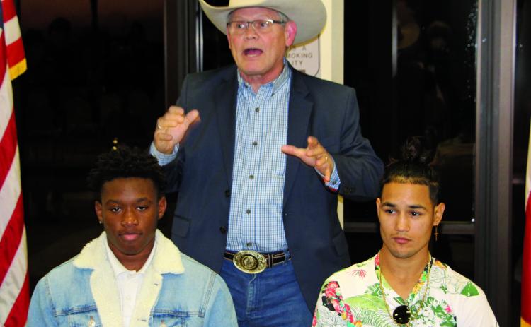 Sentinel photo/Mike Reddell Houston boxing promoter Termite Watkins (center) explains future of local boxers Kanye Gee from Bay City (left) and Tim Longoria from Palacios. The two signed professional contracts as boxers at an event Thursday, Jan. 6.