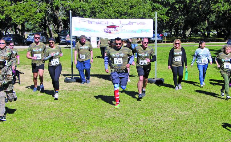 There were 18 participants in the Parks & Recreation Department’s 2022 Camo Half K Saturday morning, Jan. 29, at LeTulle Park. Cale Crowley carried Haylee Hadash on his back after the race for her to receive the trophy for the slowest runner. Other trophies went to: Robert Reed - fastest overall and male; Nicole Sears – fastest female; Stephanie Reed - best Camo. Sentinel photo/Mike Reddell