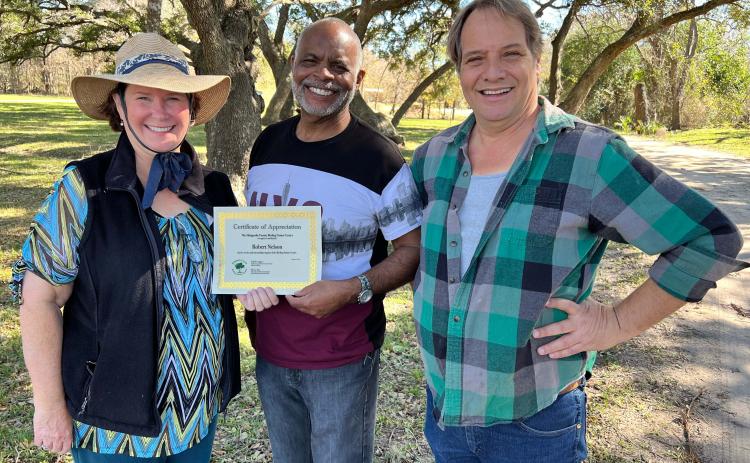 Robert Nelson, center, recently received a certificate of appreciation from Matagorda County Birding Nature Center board members Becca Sitz, left, and Stephen Logan, far right. Nelson was the winner of the Center’s "Save The Slithering Slough" fundraiser event held during the Dec. 20 Audubon Christmas Bird Count. Contributed photo